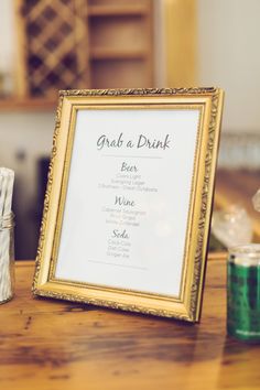 a framed menu sitting on top of a wooden table