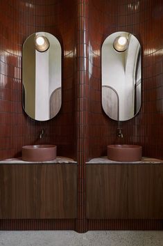 there are two sinks in the bathroom with mirrors on the wall and one is brown