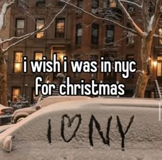 the words i wish i was in nyc for christmas are written on snow covered cars