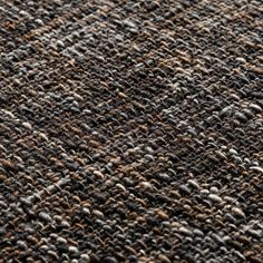 the texture of an old carpet is brown and gray