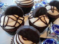 chocolate cupcakes with white frosting and drizzled on top