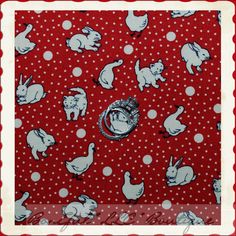 a red background with white rabbits and rings on it's head, surrounded by polka dots