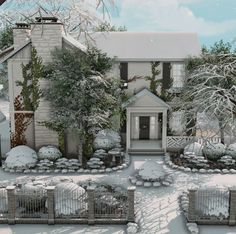 a house with snow on the ground and trees in front of it, surrounded by shrubbery