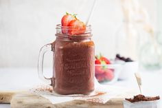 a mason jar filled with chocolate pudding and strawberries