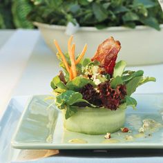 a plate topped with meat and veggies on top of a table