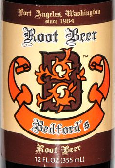 a bottle of beer with an orange ribbon around it's neck and the words root beer