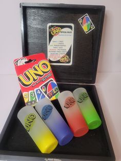 four different colored lighters in a black box