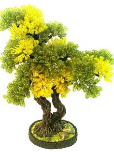 a bonsai tree with yellow flowers in it