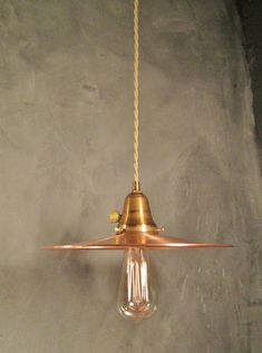 a light that is hanging from a ceiling with a cord attached to the end of it