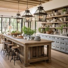 a large kitchen island with lots of pots and pans on the shelves above it