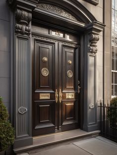 the front door of a building with two large wooden doors