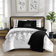 a bed with black and white comforters in a room