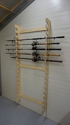 there are many fishing rods hanging on the wall