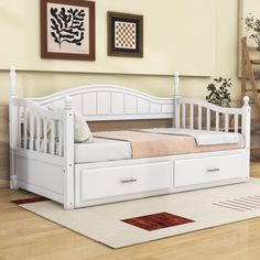 a white day bed with drawers underneath it