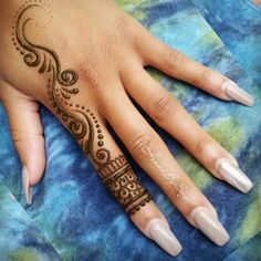 a woman's hand with henna tattoos on her left hand and the word love written