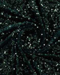 green and silver sequins on black fabric