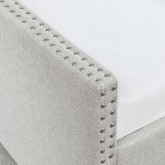 an upholstered mattress with silver studding on it