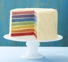 a multi - layer cake with white frosting on a plate