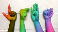 four hands are painted in different colors with the words ligtt written below them