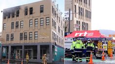 two firemen standing in front of a building