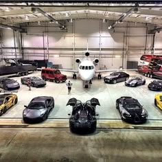 an airplane and several cars in a garage