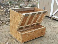 a wooden box sitting on top of a dirt field