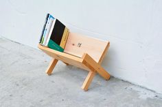 a small wooden bench with books on it