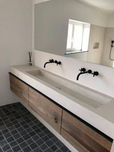 a bathroom with two sinks and a large mirror