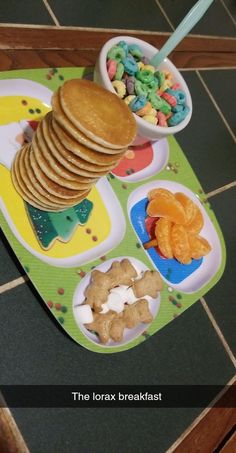 a child's play tray filled with cereal and crackers