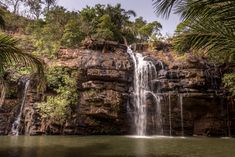 a waterfall in the middle of some trees