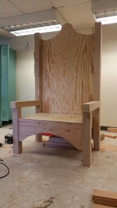 a wooden bench sitting in the middle of a room with unfinished walls and flooring