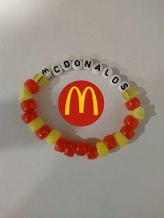 a mcdonald's bracelet with candy beads and a mcdonalds logo on the front