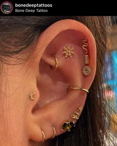 an ear with three different types of piercings on it's side, and one is