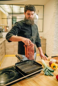 a man in an apron is cooking meat on the stove and preparing it for dinner