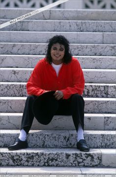 a person sitting on some steps with their legs crossed