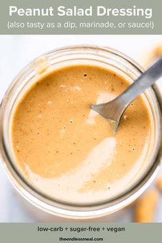 a spoon in a jar filled with peanut butter