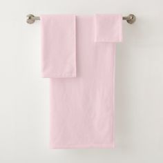 two pink towels hanging on a towel rack