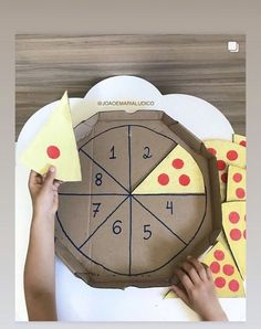 someone is making a paper clock out of cardboard