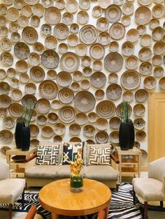 a living room filled with furniture and plates on the wall