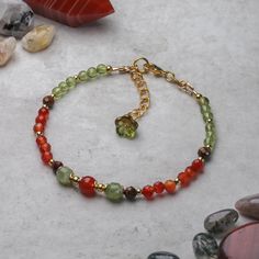 Carnelian, Peridot and Tiger Eye bracelet designed and handcrafted with care and attention to detail using:        6mm round Carnelian bead,        6mm olive shaped Peridot beads,        4mm faceted Carnelian beads,        4mm faceted Tiger Eye beads,        3.5mm round Peridot beads,        Gold plated accents. The bracelet is hand threaded onto 19 strand beading wire for flexibility and durability and fastens using superior quality 18ct gold plated lobster claw clasp. The bracelet measures 19c August Stone, Peridot Birthstone, Bracelets Ideas, Tiger Eye Bracelet, Carnelian Beads, Tiger Eye Beads, Eye Beads, Beading Wire, Eye Bracelet