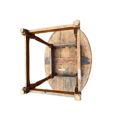 an old wooden wheel with two wheels attached to it