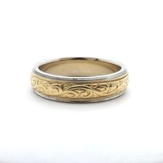 two tone gold and silver wedding ring with an intricate design on the inside of it