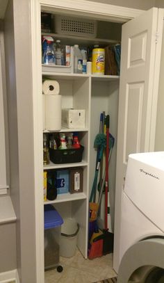 a laundry room with a washer and dryer next to the closet full of cleaning supplies