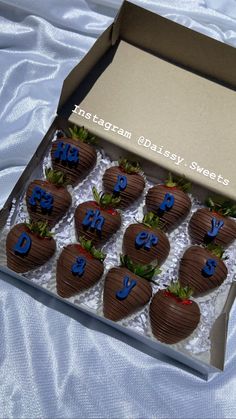 chocolate covered strawberries in a box with blue letters