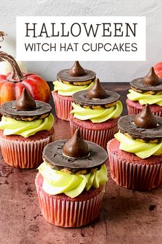 halloween cupcakes with chocolate frosting and candy on top, sitting on a table