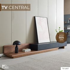 the tv is sitting on top of a wooden shelf