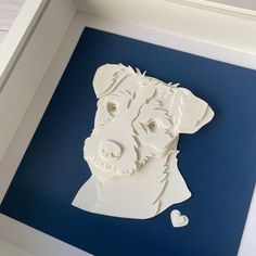 a paper cut out of a dog's face on a blue background