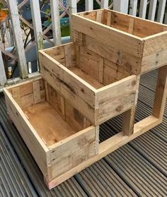 two wooden crates sitting on top of a deck