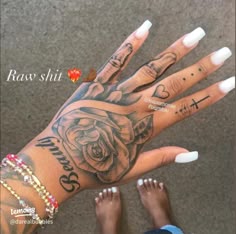 two hands with tattoos and white nails on them