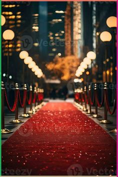 a red carpet is lined up on the side of a street with lights in the background